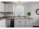 Bright kitchen showcasing a sink, modern faucet, white cabinetry, and stainless steel dishwasher at 3738 Black Feather Trl, Castle Rock, CO 80104