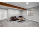 Cozy living area with a wooden beam, plush carpet, and modern furniture at 3738 Black Feather Trl, Castle Rock, CO 80104