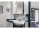 Modern powder room with decorative tile backsplash and stylish accents at 3738 Black Feather Trl, Castle Rock, CO 80104