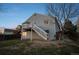 Home with a deck, white stairs leading down to the yard and mature landscaping under a dusk sky at 3738 Black Feather Trl, Castle Rock, CO 80104