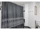 Modern shower stall with black and white tile and geometric curtains at 3738 Black Feather Trl, Castle Rock, CO 80104