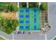 Aerial view of basketball and pickleball courts with surrounding greenery and parking at 701 Emporia St, Aurora, CO 80010