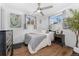 Cozy bedroom with natural light, a ceiling fan, and neutral decor, featuring hardwood floors at 701 Emporia St, Aurora, CO 80010