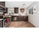 Modern kitchen with stainless steel appliances, white subway tile backsplash, and wood-look flooring at 701 Emporia St, Aurora, CO 80010