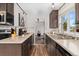 Well-appointed kitchen featuring stainless steel appliances, granite countertops, and natural light from the window at 701 Emporia St, Aurora, CO 80010