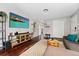 Stylish living room with hardwood floors, a modern TV and entertainment stand, and a decorative rug at 701 Emporia St, Aurora, CO 80010