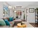 Comfortable living room with modern decor, featuring a large sectional sofa, and a dining area near bright windows at 701 Emporia St, Aurora, CO 80010