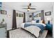 Inviting main bedroom with a large bed, ceiling fan, and two windows for ample light at 701 Emporia St, Aurora, CO 80010