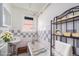 Bright bathroom features a classic bathtub with shower, vintage-style sink, and checkerboard tile at 1137 N Sherman St # 16, Denver, CO 80203