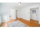 Bright bedroom with hardwood floors, large windows, and white walls offer a clean aesthetic at 1137 N Sherman St # 16, Denver, CO 80203