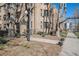 Brick exterior showcasing mature trees, vintage lamps, and wrought iron near a sidewalk at 1137 N Sherman St # 16, Denver, CO 80203