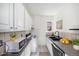 Efficient kitchen with white cabinets, black appliances, and a compact design for functionality at 1137 N Sherman St # 16, Denver, CO 80203