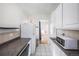 Open kitchen view with white cabinets, granite countertop and view into the dining room at 1137 N Sherman St # 16, Denver, CO 80203