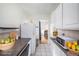 Open kitchen view with white cabinets, granite countertop and view into the dining room at 1137 N Sherman St # 16, Denver, CO 80203