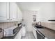 Efficient kitchen with white cabinets, black appliances, and a compact design for functionality at 1137 N Sherman St # 16, Denver, CO 80203