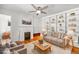 Cozy living room features built-in shelves, fireplace, ceiling fan and beautiful hardwood floors at 1137 N Sherman St # 16, Denver, CO 80203