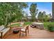 Secluded backyard featuring a jacuzzi, a fire pit, and manicured landscaping at 17372 E Prentice Cir, Centennial, CO 80015