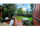Inviting backyard space with string lights, lush greenery, a wood deck, lounge furniture, and a jacuzzi for relaxation at 17372 E Prentice Cir, Centennial, CO 80015