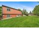 Expansive backyard with lush green lawn, a jacuzzi, and a privacy fence, perfect for outdoor activities at 17372 E Prentice Cir, Centennial, CO 80015