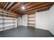 Unfinished basement featuring painted floors and wooden shelving at 17372 E Prentice Cir, Centennial, CO 80015