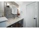 Chic bathroom with granite countertop, vessel sink, modern fixtures and decorative chevron tile at 17372 E Prentice Cir, Centennial, CO 80015