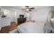 Spacious bedroom featuring wood floors, a ceiling fan, and a dresser with a modern television at 17372 E Prentice Cir, Centennial, CO 80015