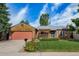 Charming home showcasing a well-manicured lawn and beautiful landscaping, perfect for outdoor enjoyment at 17372 E Prentice Cir, Centennial, CO 80015