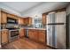 Charming kitchen features wood cabinets, modern appliances, and stylish backsplash under natural lighting at 17372 E Prentice Cir, Centennial, CO 80015