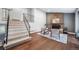 Open concept living room features a brick fireplace and staircase at 17372 E Prentice Cir, Centennial, CO 80015