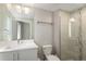 The bathroom has a single sink vanity, a modern shower with glass doors, and modern lighting at 2374 S University Blvd # 202, Denver, CO 80210