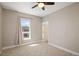 This bedroom features neutral walls and carpet, with a fan and a window, offering a serene and inviting space at 2374 S University Blvd # 202, Denver, CO 80210