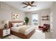 Modern bedroom with a ceiling fan, large window, and a curated aesthetic, creating a relaxing retreat at 2374 S University Blvd # 202, Denver, CO 80210