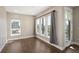 Well-lit bedroom with hardwood floors, large windows, and balcony access at 2374 S University Blvd # 202, Denver, CO 80210
