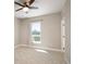 Bright bedroom features neutral carpeting, a ceiling fan, and a large window for natural light at 2374 S University Blvd # 202, Denver, CO 80210