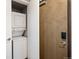 Hallway closet featuring a stacked washer and dryer at 2374 S University Blvd # 202, Denver, CO 80210