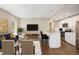 Comfortable living room and modern kitchen featuring stainless steel appliances and an island with seating at 2374 S University Blvd # 202, Denver, CO 80210