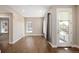 Bright living area with hardwood floors, large windows, and access to a balcony at 2374 S University Blvd # 202, Denver, CO 80210