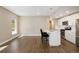 Open-concept living area showcasing a modern kitchen with an island and seating at 2374 S University Blvd # 202, Denver, CO 80210