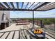 Inviting rooftop deck with a fire pit, seating, and a grill at 2374 S University Blvd # 202, Denver, CO 80210