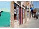 Commercial storefront with brick facade and painted murals, including a blue painted wall on the left at 2374 S University Blvd # 202, Denver, CO 80210
