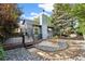 Landscaped backyard featuring a deck, garden beds, decorative rocks, and mature trees at 517 Chiswick Cir, Highlands Ranch, CO 80126