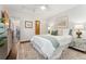 Spacious bedroom features an ensuite bathroom, ceiling fan, and stylish decor with calming color palette at 517 Chiswick Cir, Highlands Ranch, CO 80126