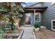 Inviting front entrance with a dark wood door, stone steps, and well maintained landscaping at 517 Chiswick Cir, Highlands Ranch, CO 80126