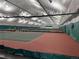 Spacious indoor tennis and pickleball courts with nets, benches, and comfortable playing surfaces at 517 Chiswick Cir, Highlands Ranch, CO 80126