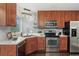 Well-appointed kitchen with stainless steel appliances, white countertops, and ample cabinet space at 517 Chiswick Cir, Highlands Ranch, CO 80126