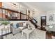 Spacious living room showcasing the open floor plan, dark wood floors, and staircase access at 517 Chiswick Cir, Highlands Ranch, CO 80126