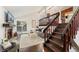 Bright living room showcasing the open floor plan with access to the kitchen and beautiful staircase at 517 Chiswick Cir, Highlands Ranch, CO 80126