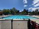 Large outdoor pool with lap lanes, seating areas, and lifeguard stands, ideal for summer enjoyment at 517 Chiswick Cir, Highlands Ranch, CO 80126