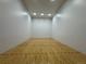 Racquetball court with white walls and a hardwood floor marked with red lines at 517 Chiswick Cir, Highlands Ranch, CO 80126