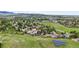 Aerial view of a residential neighborhood with lush greenery, solar panels, and a scenic mountain backdrop at 225 Berthoud Way, Golden, CO 80401